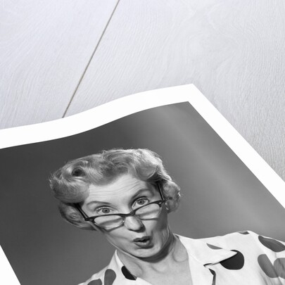 1950s 1960s Portrait Woman Polka Dot Dress Looking Over Eyeglasses by Anonymous