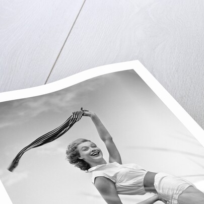 1950s 1960s Young Woman Bending Back Holding Scarf In The Wind Standing On Grassy Beach Dune by Anonymous