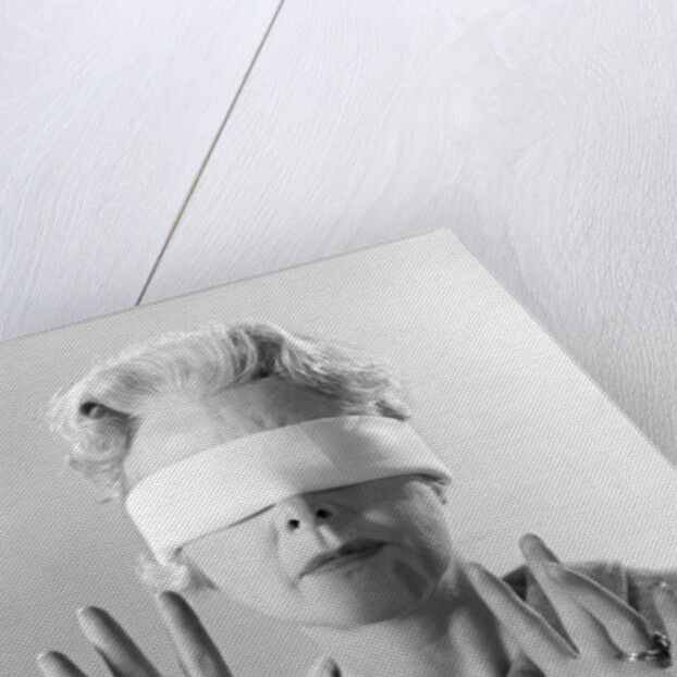 1960s Elderly Woman Wearing Blindfold Holding Up Her Hands by Anonymous
