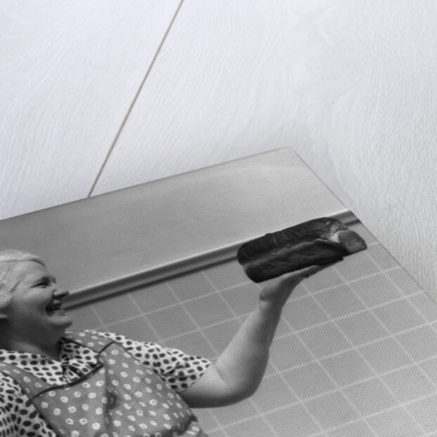 1930s 1940s Grandmother In Apron Admiring Loaf Of Freshly Baked Bread by Anonymous