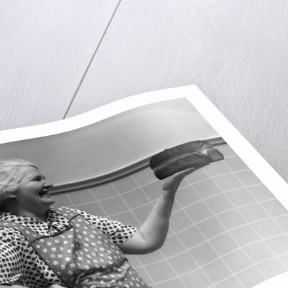 1930s 1940s Grandmother In Apron Admiring Loaf Of Freshly Baked Bread by Anonymous