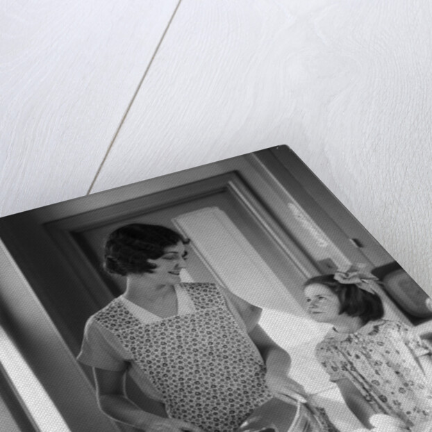 1920s 1930s Mother With Mixing Bowl In Kitchen With Daughter by Anonymous