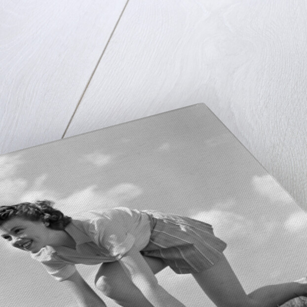 1940s Young Teen Woman Kneeling In Grass In Track Race Ready Starting Position by Anonymous