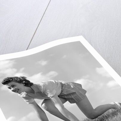 1940s Young Teen Woman Kneeling In Grass In Track Race Ready Starting Position by Anonymous