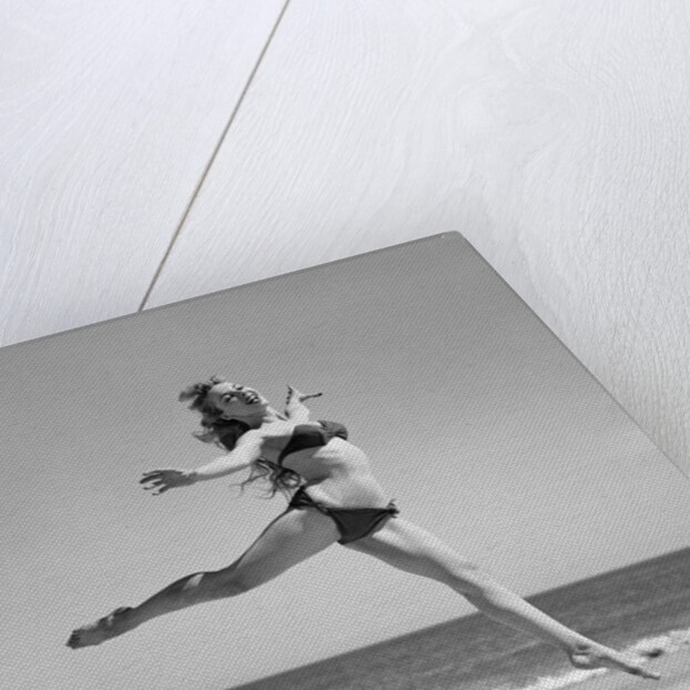 1950s Woman In Bikini Running And Jumping On The Beach Smiling by Anonymous