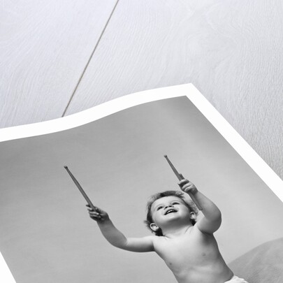 1940s Baby In Diaper With Drum Holding Up Drumsticks by Anonymous