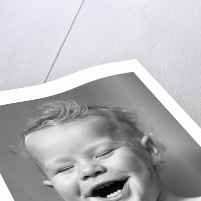 1940s Portrait Baby With Messy Hair Laughing With Eyes Closed by Anonymous