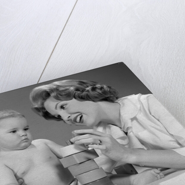 1960s Mother And Unhappy Baby Playing With Blocks by Anonymous