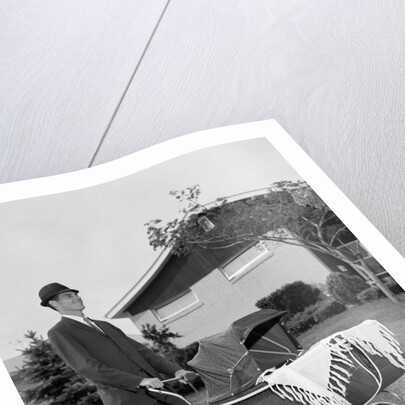 1960s Man Pushing Stroller Baby Carriage Suburban Sidewalk by Anonymous