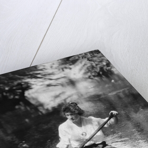 1920s Woman With Upswept Hair Paddling Wooden Canoe In Stream by Anonymous