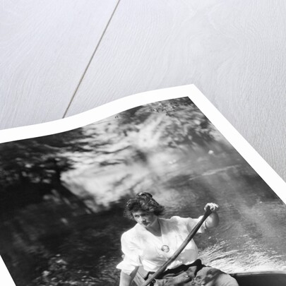 1920s Woman With Upswept Hair Paddling Wooden Canoe In Stream by Anonymous