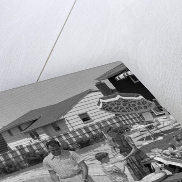 1950s Family In Backyard Beside Pool Having Cookout Of Hot Dogs and Hamburgers by Anonymous