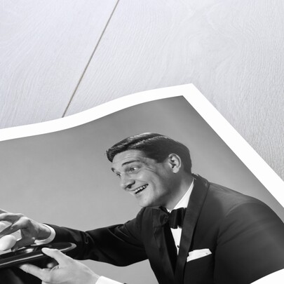 1960s Profile Magician Man Pulling 4 Eggs Out Of Hat Holding Them Between Fingers by Anonymous