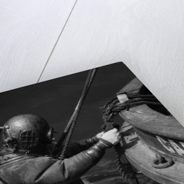 1930s Side View Of Diver In Pressure Suit Descending Into Water From Side Of Boat by Anonymous