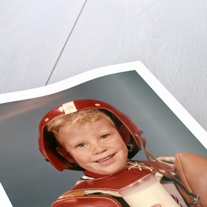 1960s Boy Wearing Red Helmet Football Shoulder Pads Holding Glass Milk and Football by Anonymous