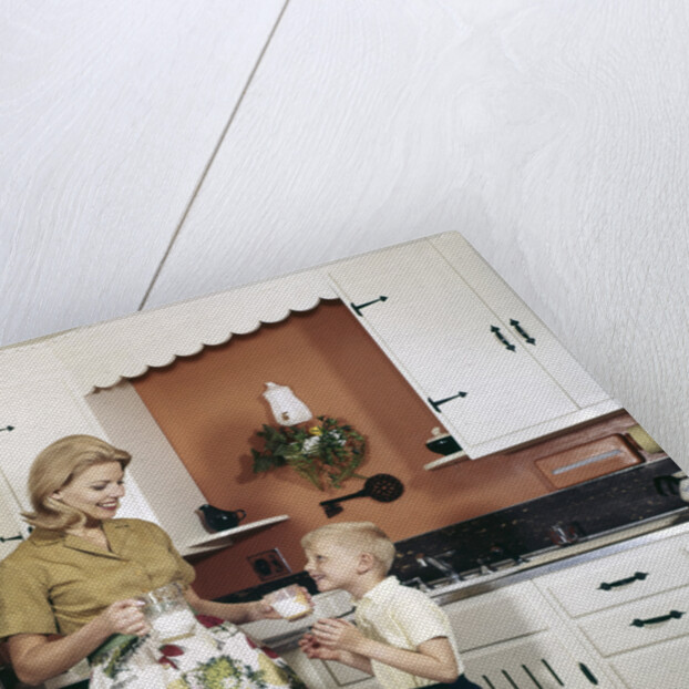 1970s Mother Handing Glass Of Milk To Son In Kitchen by Anonymous