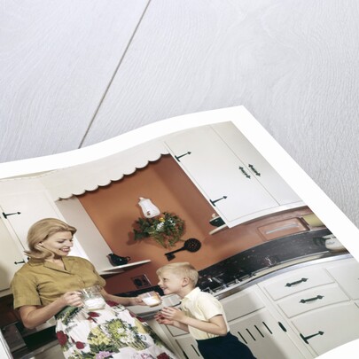 1970s Mother Handing Glass Of Milk To Son In Kitchen by Anonymous