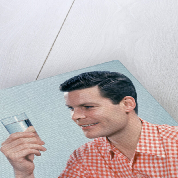 1960s Profile Man Wearing Red Checkered Shirt Holding Glass Of Water by Anonymous