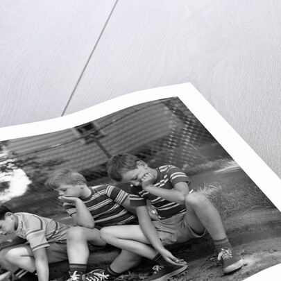 1970s Three Bored Boys Sitting On Curb All Wearing Striped Tee Shirts Shorts And Sneakers by Anonymous