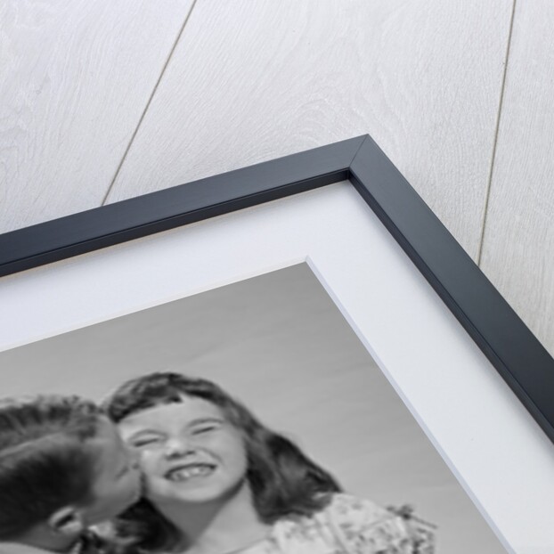 1950s 1960s Boy In Vest and Bow Tie Holding Valentine Candy Kissing Cheek Of Girl Making A Face by Anonymous