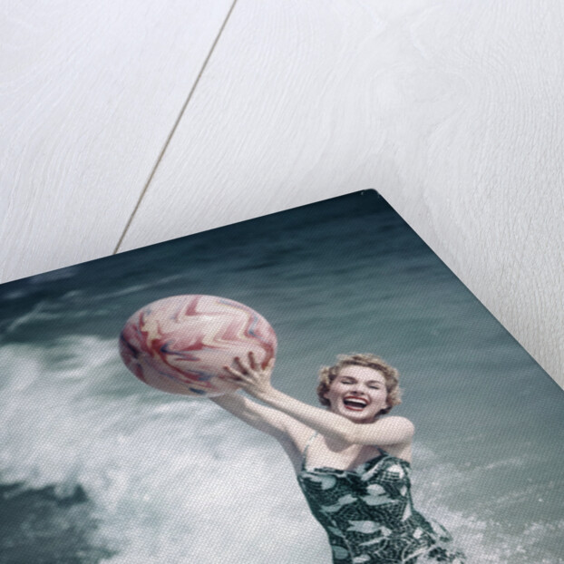 1950s Woman Jumping In Surf Holding Up Beach Ball by Anonymous