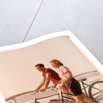 1950s 1960s Teen Couple Standing By Bikes On Beach Boardwalk by Anonymous