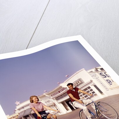 1950s Teen Couple Riding Bikes On The Boardwalk Jersey Shore by Anonymous