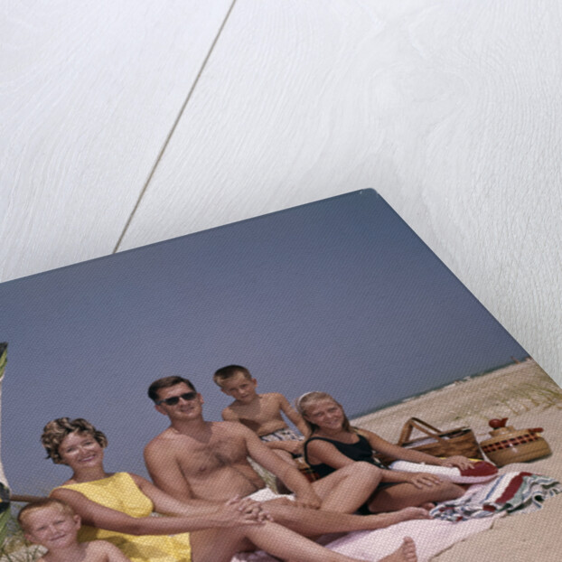 1960s Family On Sunny Beach Under Umbrella With Picnic Basket by Anonymous