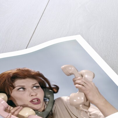 1960s Frustrated Young Redheaded Woman Trying To Answer Handle Five Telephone Receivers Studio by Anonymous
