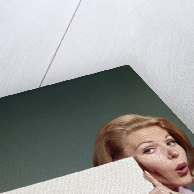 1960s Portrait Of Surprised Woman Peeking Around Sign Board by Anonymous