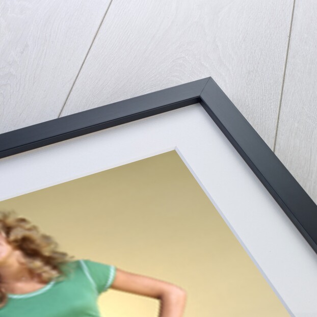 1970s Young Woman With Long Curly Hair Standing Hands On Hips In Bell Bottom Denim Blue Jeans by Anonymous