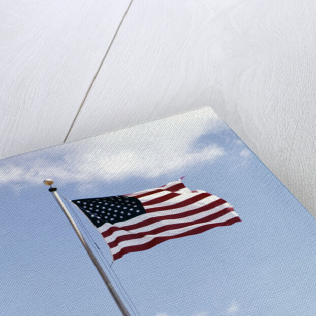 1960s American Flag On Pole Flying Against Blue Sky With Clouds by Anonymous