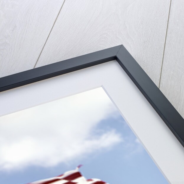 1960s American Flag On Pole Flying Against Blue Sky With Clouds by Anonymous