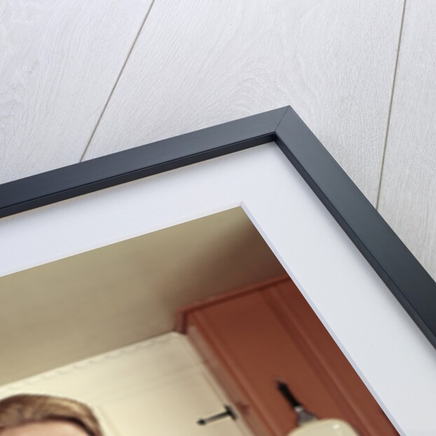 1960s Young Housewife While Checking Grocery Shopping Receipt In Kitchen by Anonymous