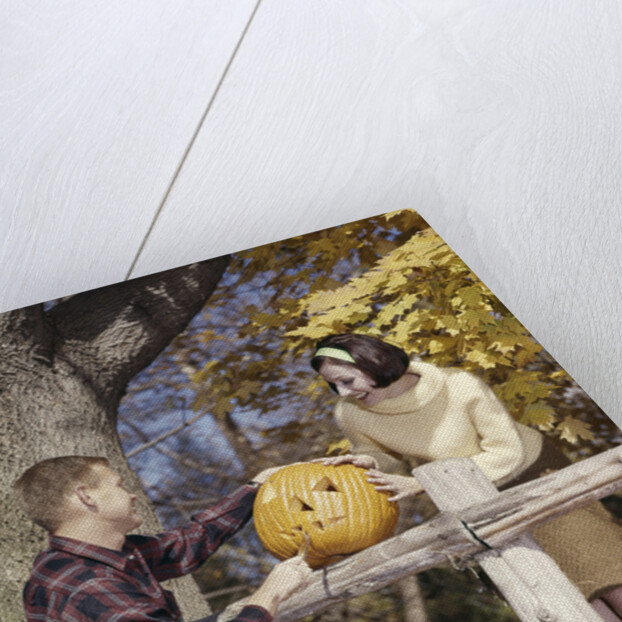1960s Young Couple Man Woman In Autumn Woods Carving Halloween Jack-O-Lantern Pumpkin by Anonymous