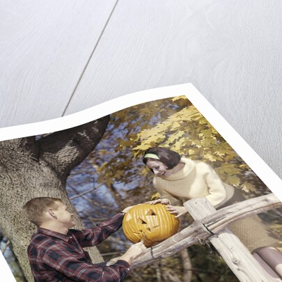 1960s Young Couple Man Woman In Autumn Woods Carving Halloween Jack-O-Lantern Pumpkin by Anonymous