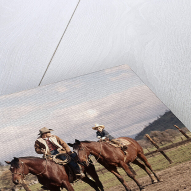 1970s Father And Son Sitting Together On Horses By Corral Wearing Hats by Anonymous