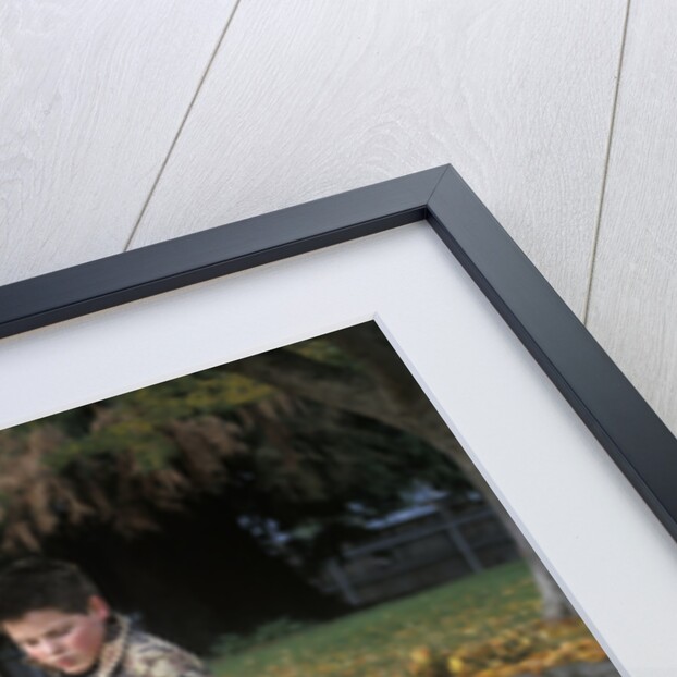 1970s 1980s Teenage Boy Raking Autumn Leaves by Anonymous