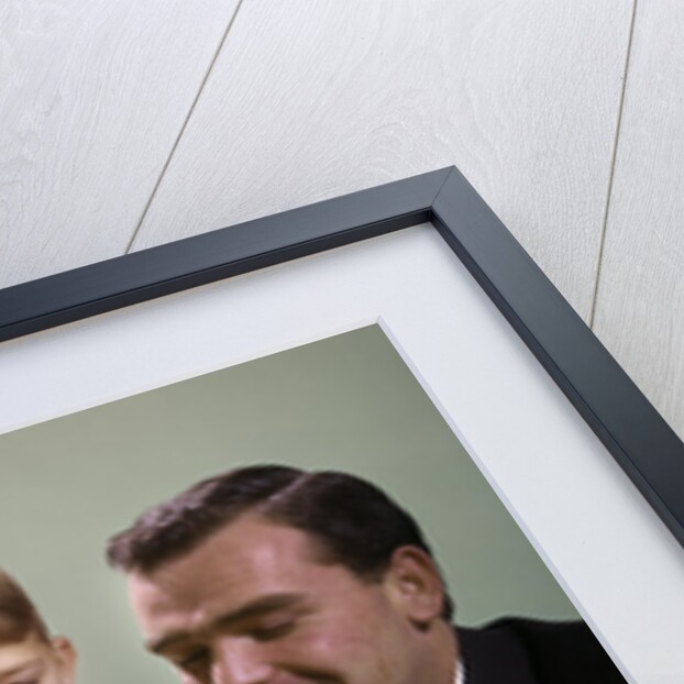 1960s Mother And Father Holding Birthday Cake And Sons Blowing Out Candles by Anonymous