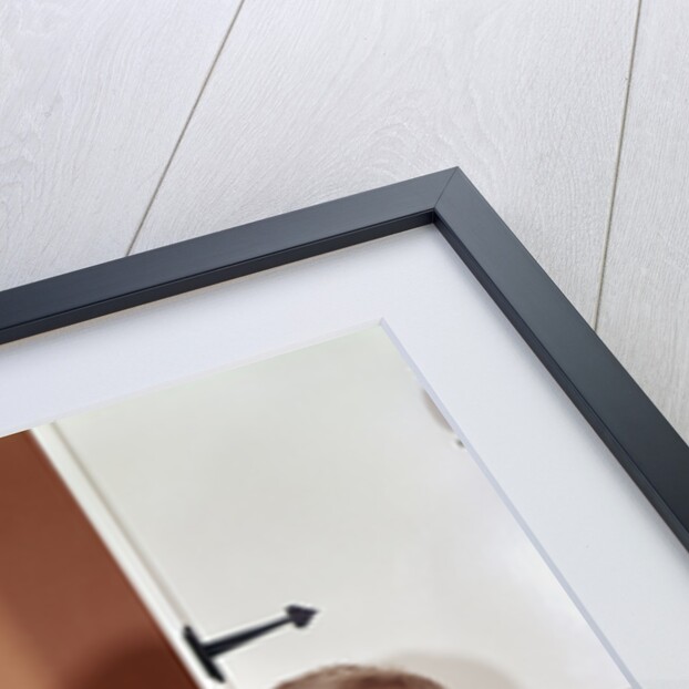 1970s Mother Giving First-Aid Putting Band-Aid On Knee Of Son In Kitchen by Anonymous