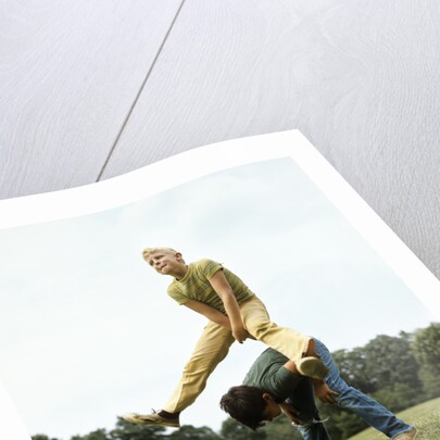 1970s Two Boys Jumping Playing Leapfrog by Corbis