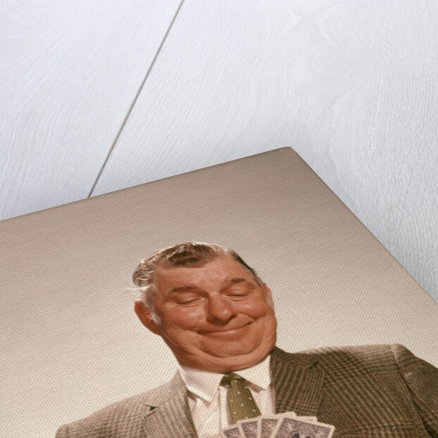 1960s Satisfied Man Looking At Hand Of Playing Cards by Anonymous
