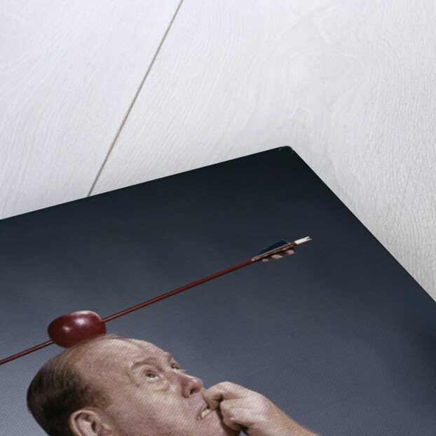 1960s Anxious Business Man Biting Finger With Nails Arrow Shot Through Apple On Of His Top Head by Anonymous