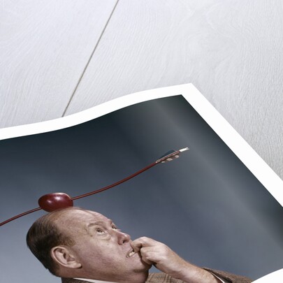 1960s Anxious Business Man Biting Finger With Nails Arrow Shot Through Apple On Of His Top Head by Anonymous