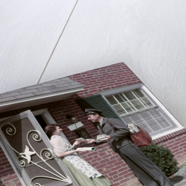 1950s Mailman Delivering Mail To Woman Brick Suburban Home by Anonymous