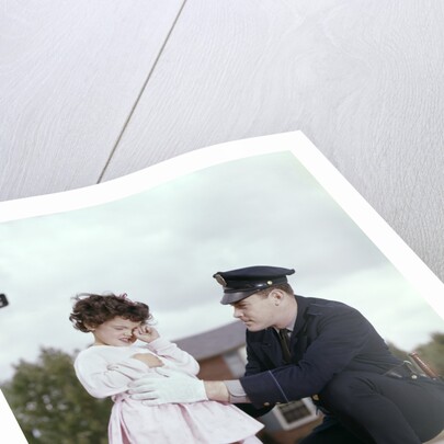 1960s Man Police Officer Comforting Crying Scared Little Lost Girl In Suburban Neighborhood by Anonymous