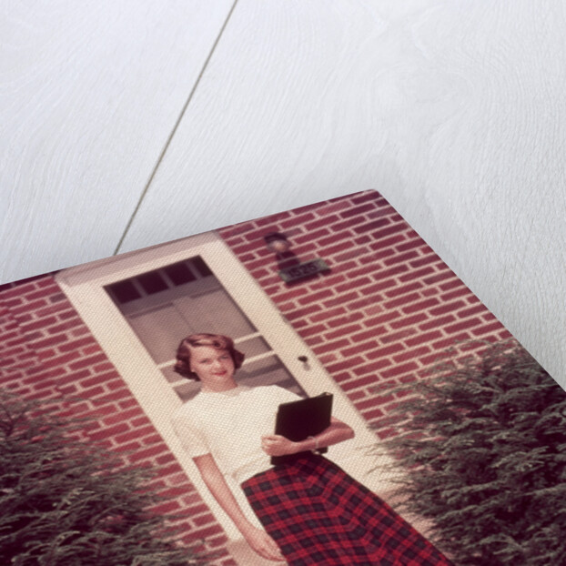 1950s Teenage Girl Holding School Books Walking Down Flagstone Walk by Anonymous