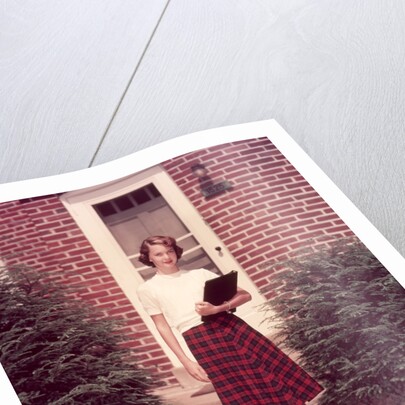 1950s Teenage Girl Holding School Books Walking Down Flagstone Walk by Anonymous