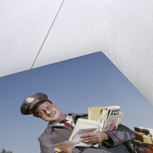 1960s Mailman Holding Letters Mail Leather Mailbag In Suburban Neighborhood by Anonymous