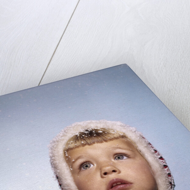 1960s Cold Little Girl In Winter Coat And Hood Looking Up At Falling Snow by Anonymous